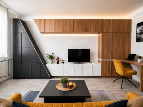 a living room with a couch and a tv at Comfort 65 2-Bedroom Apartment with Balcony in Miskolc