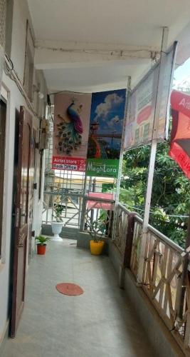 a hallway of a building with posters on the walls at Hotel MeghTora in Goālpāra