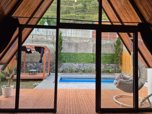 a view from the inside of a house with a pool at Aira Private Pool Glamping in Bandung