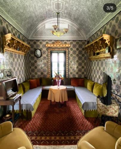 a living room with a couch and a table at Darelkhir in Tazarka