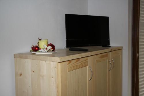 a flat screen tv on top of a wooden cabinet at S4 Resort Kouty in Loučná nad Desnou