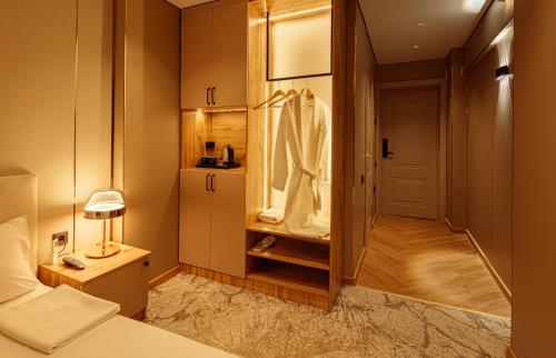a bedroom with a bed and a dressing room at EUROPA Hotel in Semey