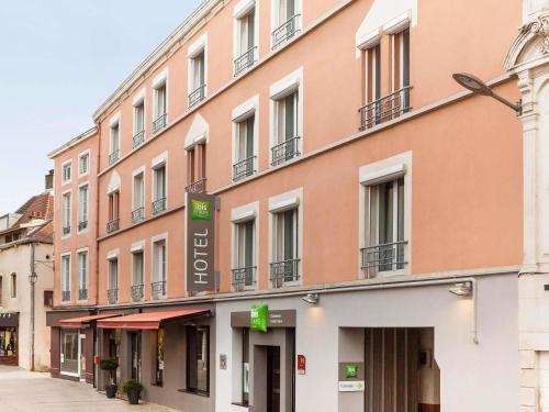 a large pink building with a sign on it at ibis Styles Chaumont Centre Gare in Chaumont