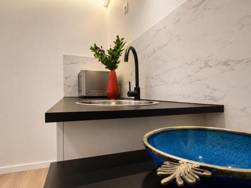 a kitchen with a sink and a blue tub at Centerstay Brussels in Brussels