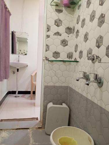 a bathroom with a toilet and a sink at Ashish Aram Ghar in Ujjain