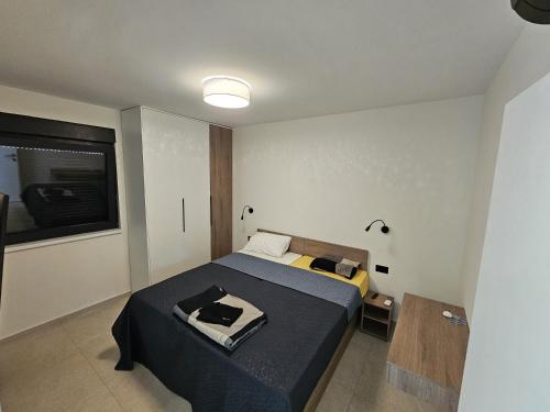a bedroom with a bed with a black blanket at Vila Dora with Private Pool in Radetići