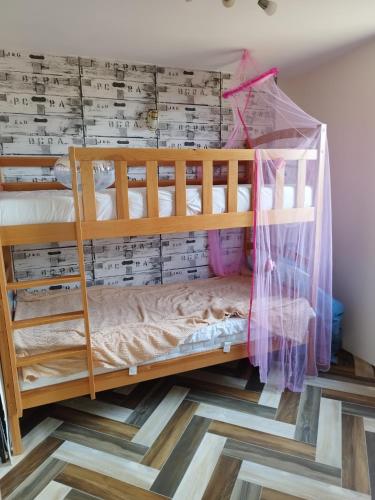 a bedroom with bunk beds with a wall with music on it at Betlejem Nad Jeziorem in Gostyczyn
