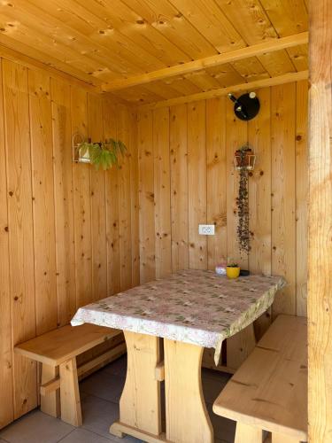 a wooden sauna with a stone table and benches at Princess Mojca Holiday House in Bled