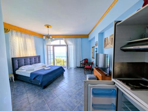 a bedroom with a bed and a tv in a room at Madalenas B&B in Pelekas