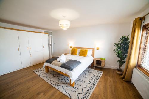 a bedroom with a bed and a rug at High Street Retreat in Whitstable