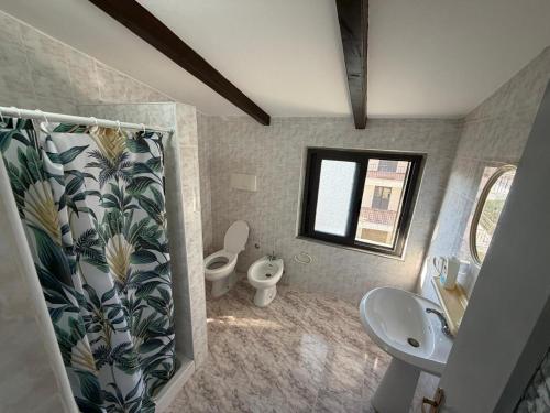 a bathroom with a sink and a toilet and a sink at Villa Emma Durrës in Durrës