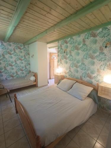 a bedroom with a bed in a room with a wall at Les Murmures de la Forêt Bed and Breakfast in Lanas
