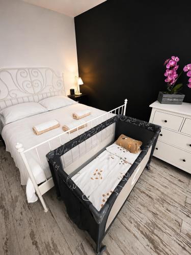 a bedroom with a white bed and a white dresser at Zlatá Víla by Cañas Apartments V srdci mesta, len pár krokov od hlavného námestia in Rimavská Sobota