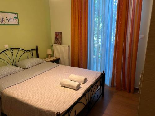 a bedroom with a bed with two towels on it at Harision Residence in Sparta