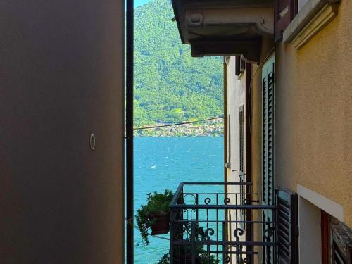 a view of the water from a balcony of a building at White Suite Lakeside in Colonno