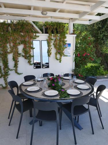 a table set up for a meal on a patio at Okeanos Vine Luxury Villa in Athani