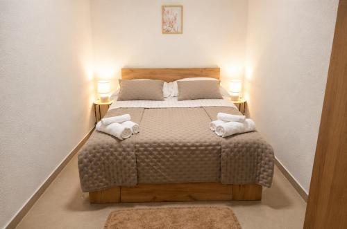 a bedroom with a large bed with towels on it at Christina in Otok