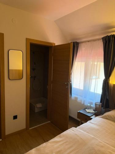 a bedroom with a bed and a bathroom with a shower at Gaja in Križpolje