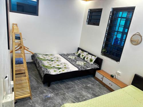 a bedroom with a bed and a ladder in it at NinhBinh Central Homestay l Green Path in Xuân Sơn