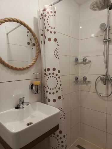 a bathroom with a sink and a shower at Przystanek Natura in Radzie