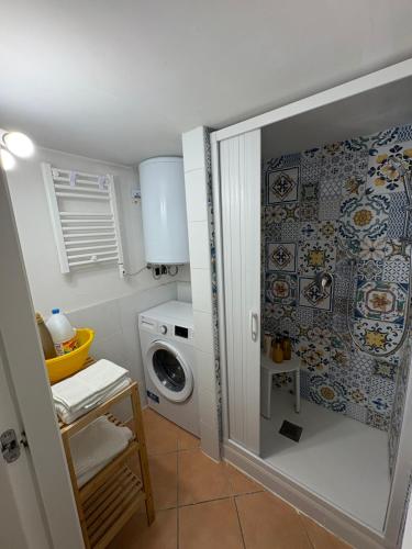 a small bathroom with a washing machine and a washer at Caterina 70 in Naples
