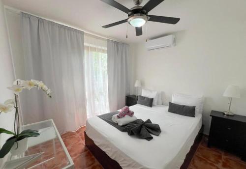 a bedroom with two beds and a ceiling fan at CARIBBEAN DREAMS Apartment & Villas - OCEAN VIEW - POOL - BBQ in Punta Cana