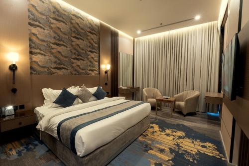 a hotel room with a bed and a television at Mora Hotel in Jeddah