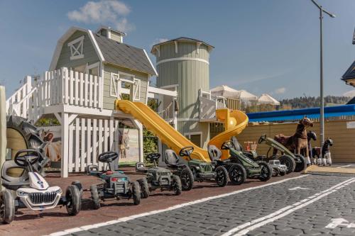a group of vehicles parked next to a playground at Panocek in Białka Tatrzańska
