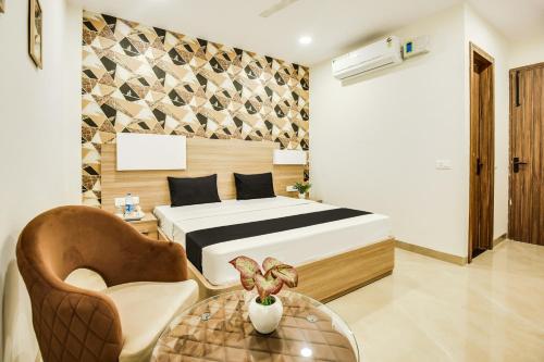 a bedroom with a bed and a chair and a table at Heritage Villa in Ludhiana
