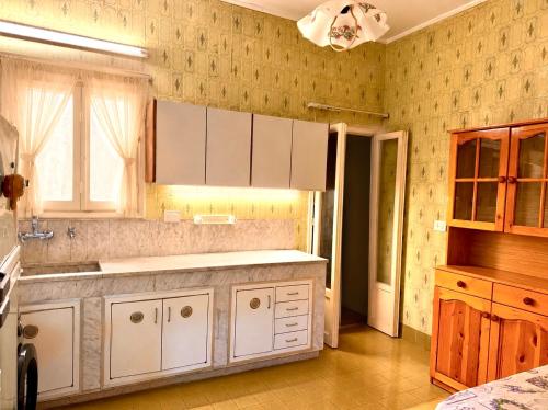 a kitchen with white cabinets and a sink at Spacious Mountain House In Sehayleh in Ḩayy ash Shabbūq