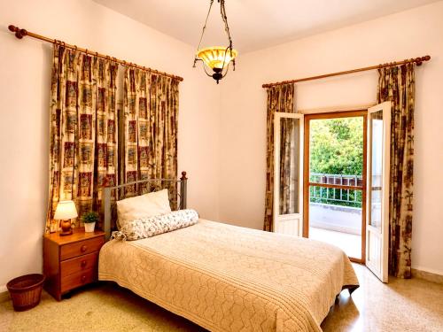 a bedroom with a bed and a sliding glass door at Spacious Mountain House In Sehayleh in Ḩayy ash Shabbūq
