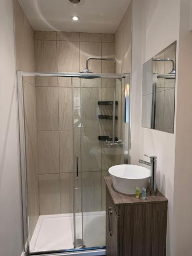 a bathroom with a shower and a sink at The Crown in Hawes