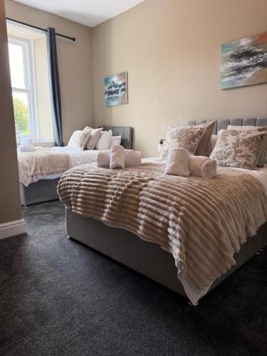 a bedroom with two beds and a window at The Crown in Hawes