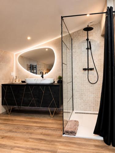 a bathroom with a sink and a shower at La Bohème Mouriès in Mouriès