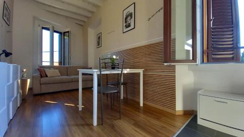 a living room with a table and a couch at Cavour 35 in Sulbiate