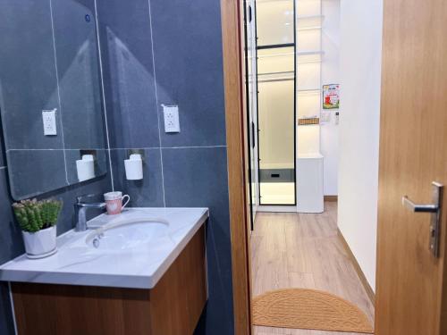 a bathroom with a sink and a shower at Jadore House in Danang