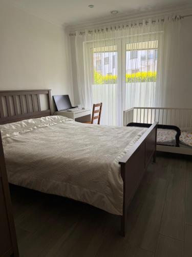 a bedroom with a bed and a desk with a laptop at Terraced apartment in Kayl