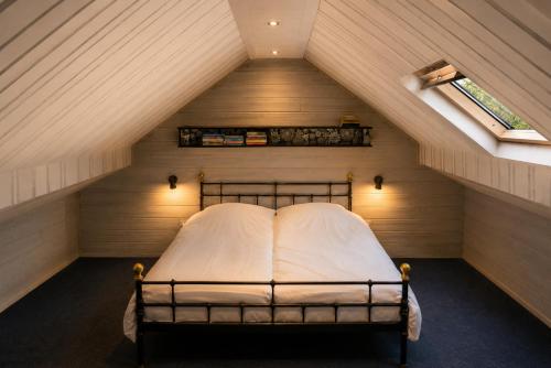 a bedroom with a bed in a attic at Kamer midden in de Ardennen in Amblève