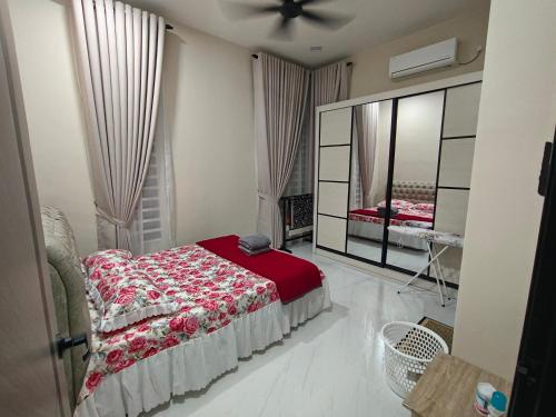 a bedroom with a bed and a large mirror at D'Jawa Homestay in Baling