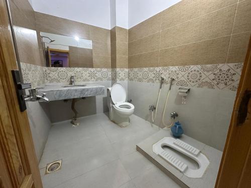 a bathroom with a toilet and a sink at Taj luxury hotel Quetta in Quetta