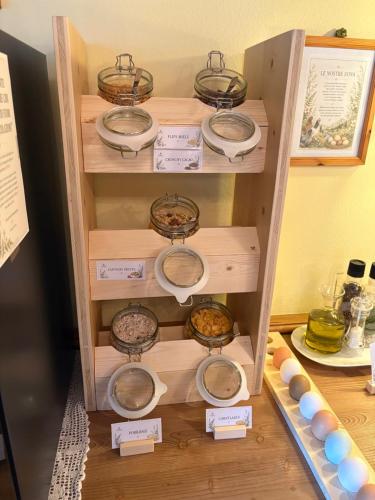 a wooden shelf with bowls of food on it at Chalet La Felce in Carisolo