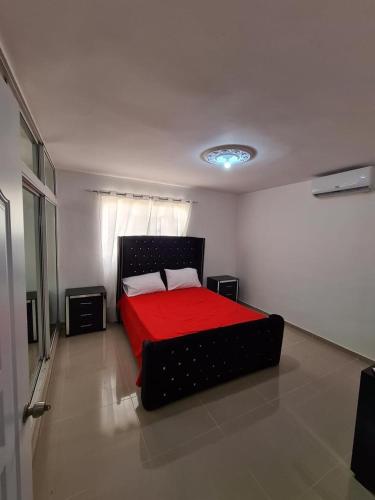 a bedroom with a bed with a red blanket at Apartment Ñ4 in La Grúa