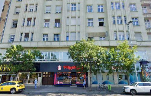 a large building with cars parked in front of it at ZOOM Apartments - Budapest in Budapest