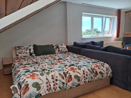 a bedroom with a bed and a couch at Apartment 3 floor in Vratimov