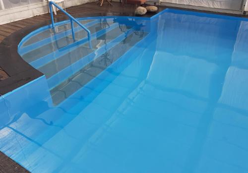 a large swimming pool with blue water at Brise Fraîche de la Montagne-Piscine et Jacuzzi-Appartement Cottage au rez-de-chaussée in Le Poujol-sur-Orb