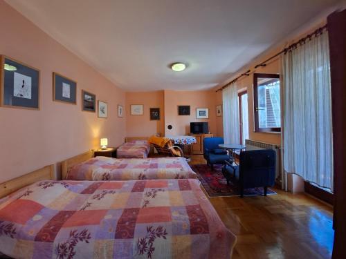a hotel room with two beds and a table and chairs at Apartments Grace in Rovinj