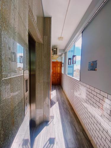 a hallway of a building with a door and brick walls at Lighthouse Homestay Vũng Tàu in Vung Tau