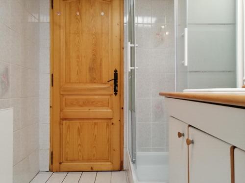 a wooden door in a bathroom with a shower at Le Paradis du Chalet Perce-Neige in Châtel-Saint-Denis