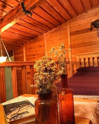 a vase with flowers on a table in a cabin at Chalet Gyumri in Gyumri