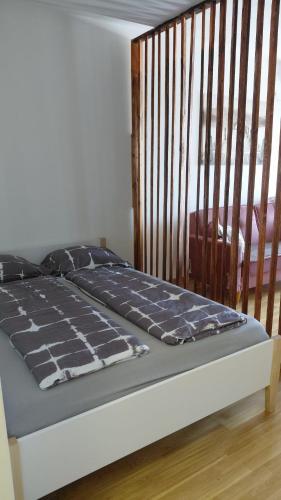 a bed in a bedroom with a wooden headboard at Cozy Studio-Self check in in Beograd